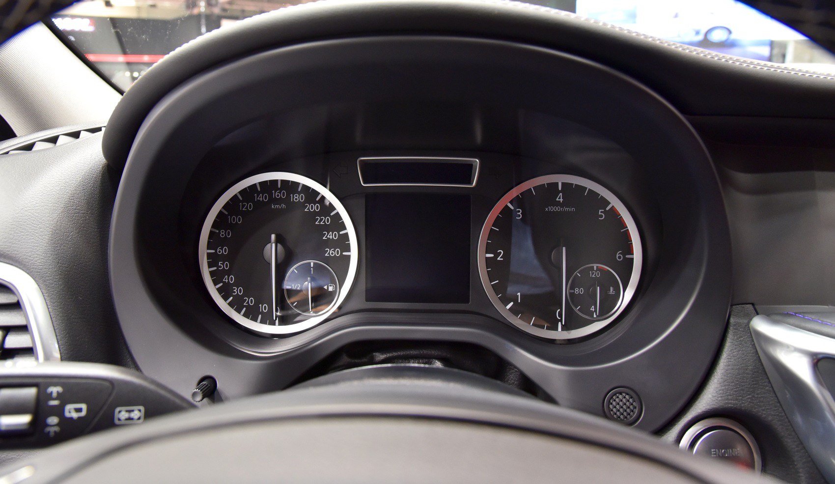 Speedometer, tachometer, fuel and temperature gauges on a car instrument cluster