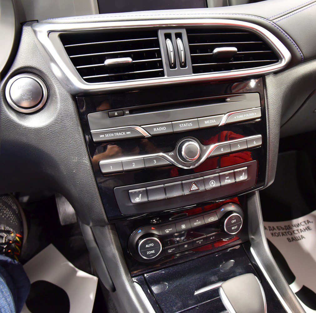 Center console with air vents, media and climate controls, engine start button