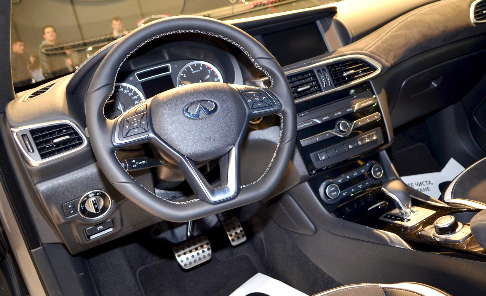 Dashboard and steering wheel with controls and display.