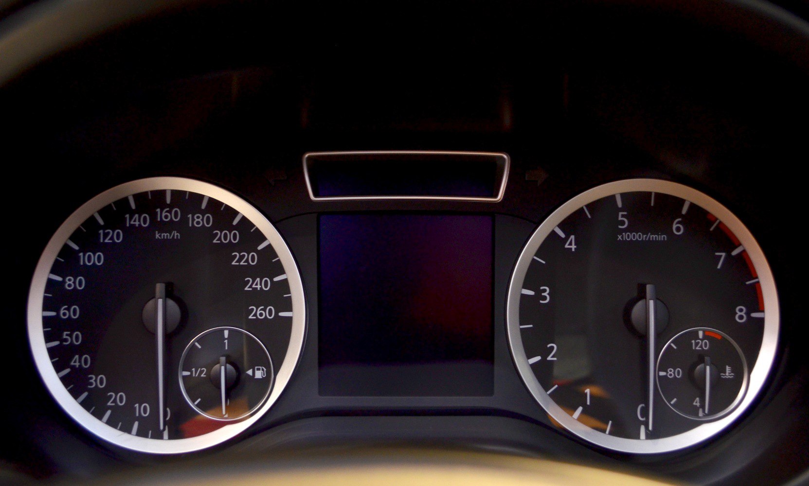 Speedometer, tachometer, fuel and temperature gauges on car dashboard