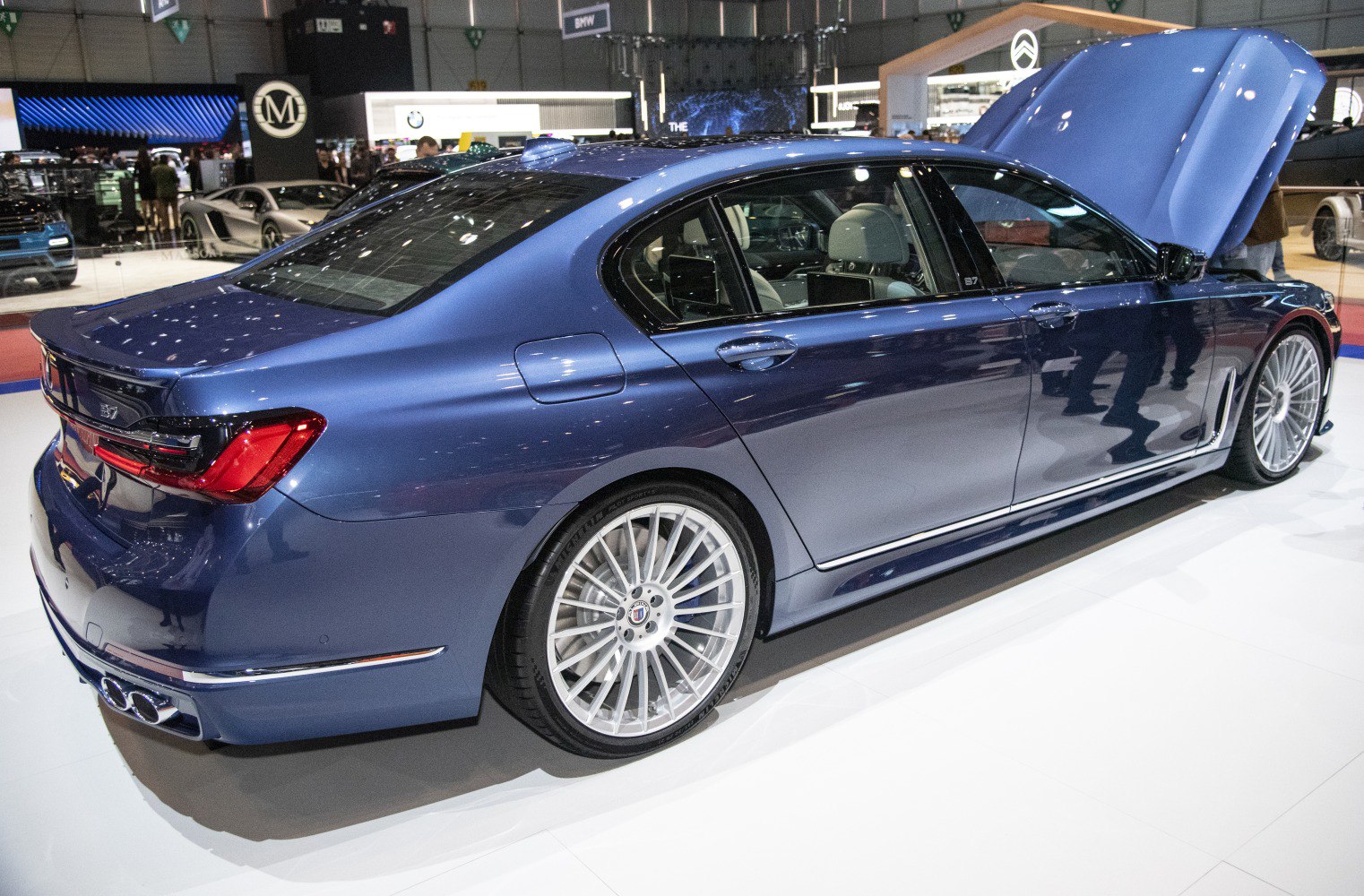 Rear side view with multi-spoke wheels and quad exhaust