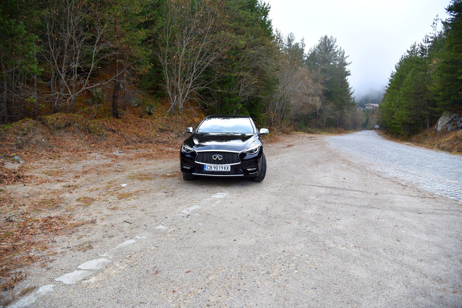 Front view of sleek black car with intricate grille and LED headlights