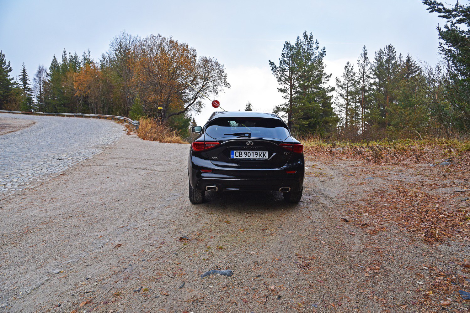 Rear view of black AWD hatchback with dual exhaust and modern tail lights