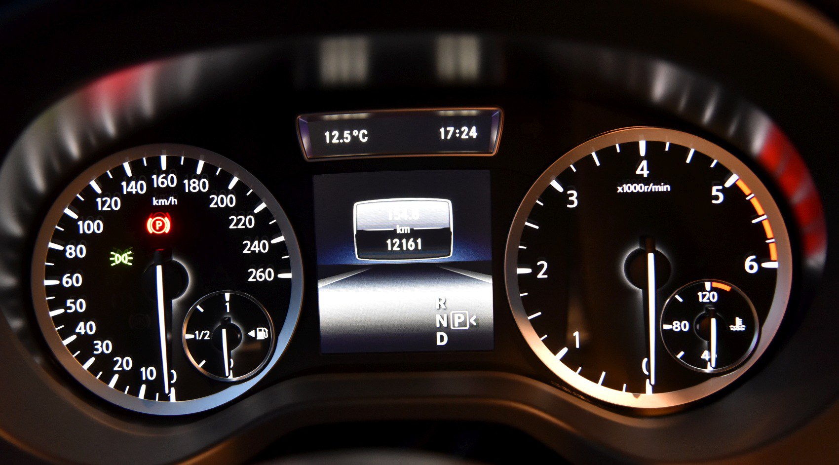 Car dashboard with speedometer and tachometer displays
