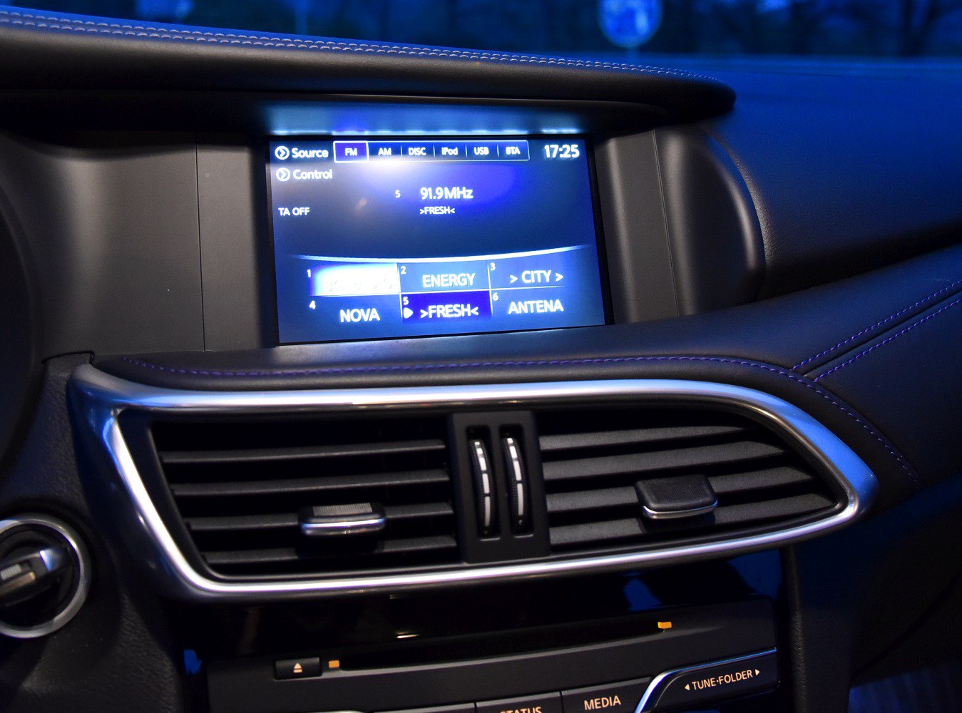 Infotainment screen and central air vents in car interior