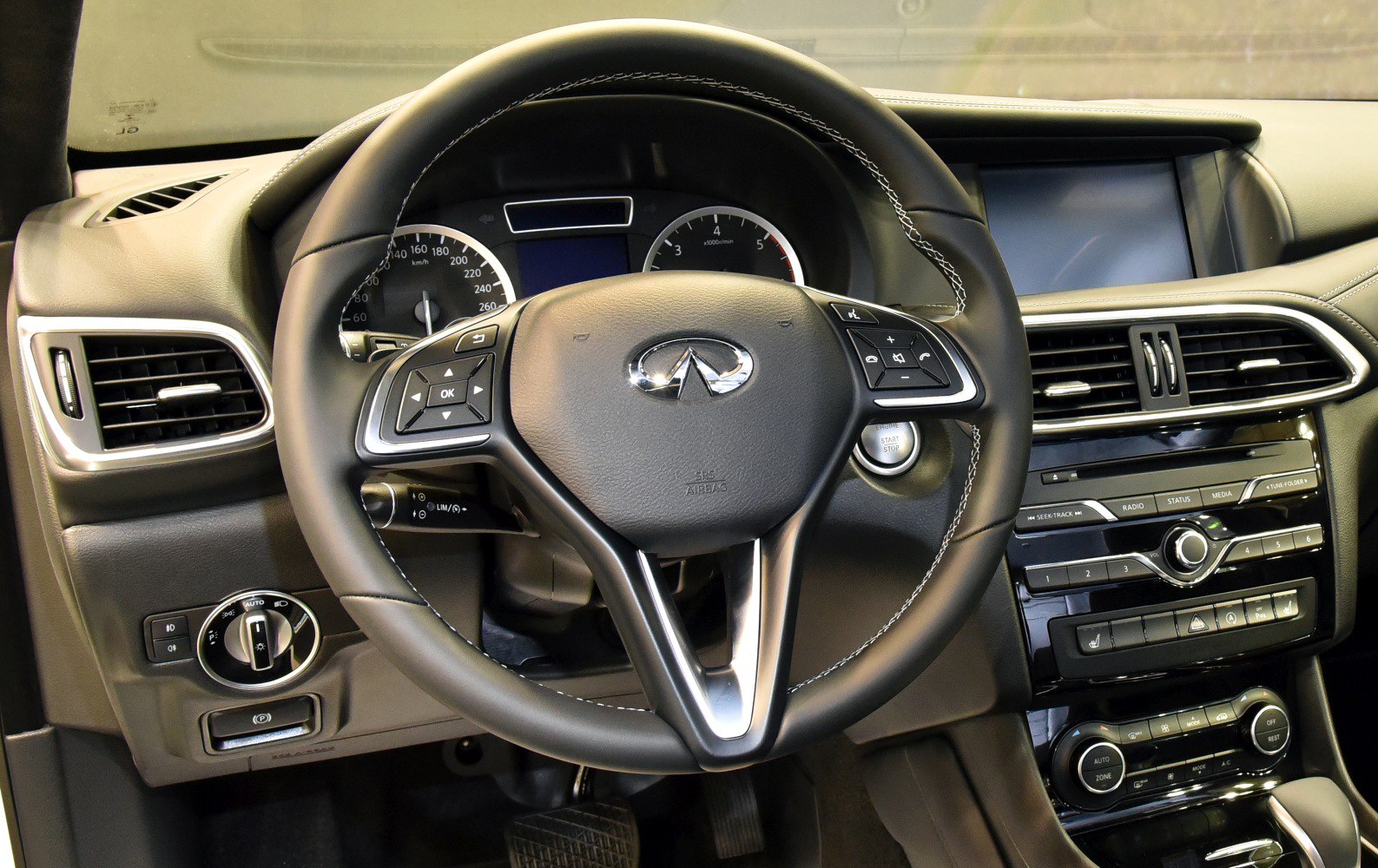 Steering wheel, instrument cluster, and center console controls of a car interior