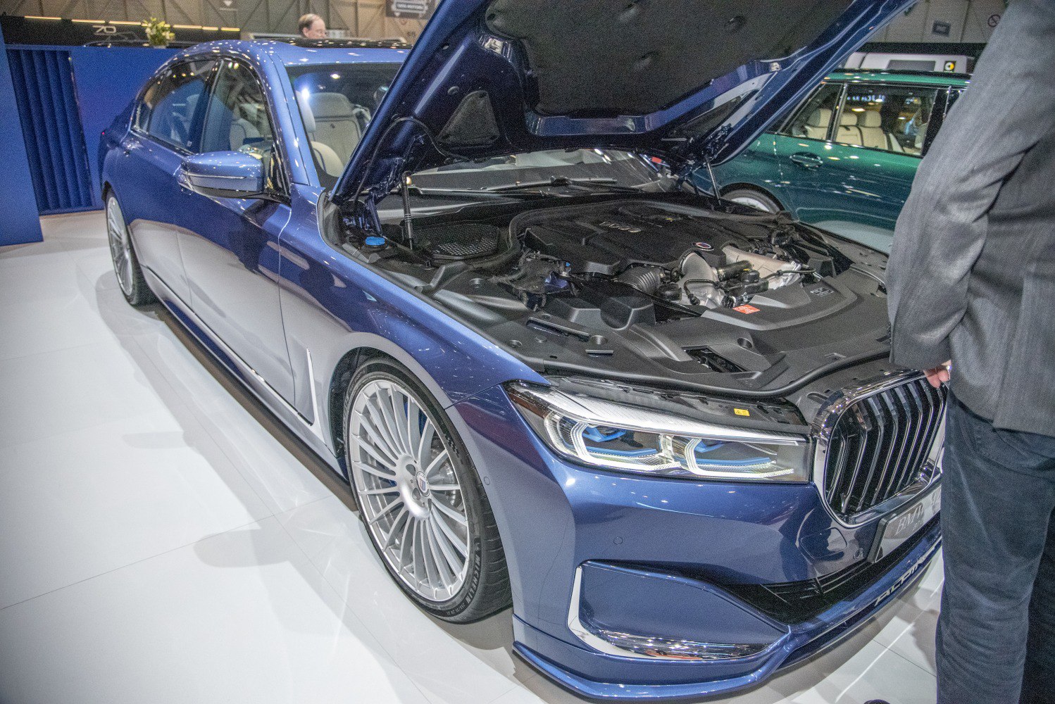 Open hood showing engine bay and front design of luxury sedan