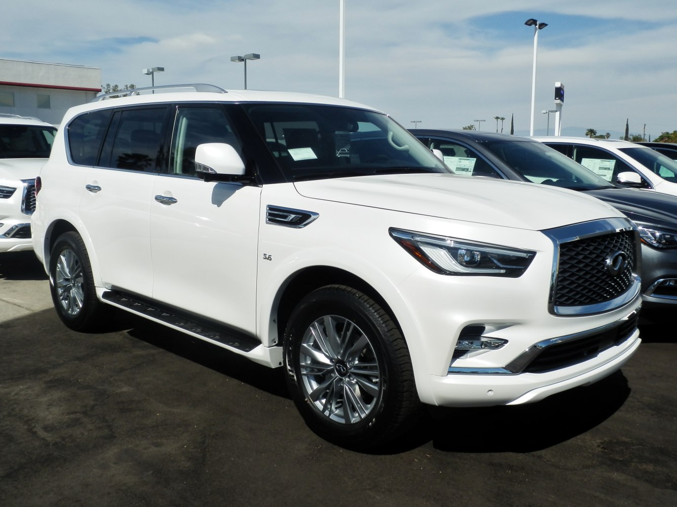 White luxury full-size SUV with chrome grille and LED headlights