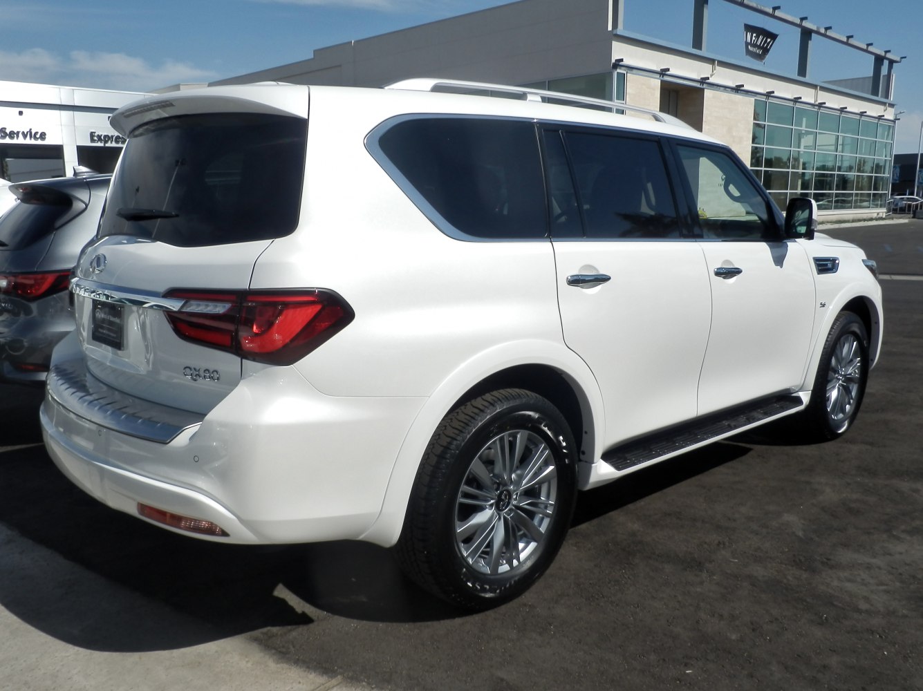 Rear and side view of large luxury SUV with tinted windows and alloy wheels
