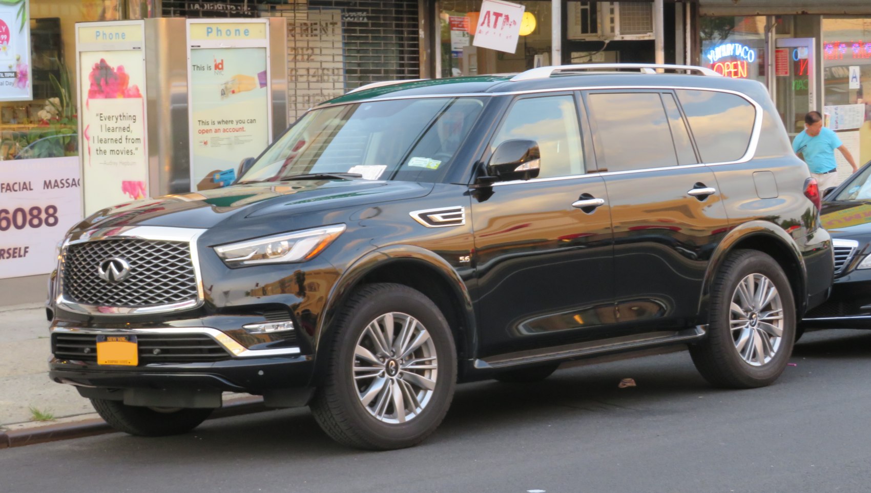 Black SUV front side profile with large grille and alloy wheels