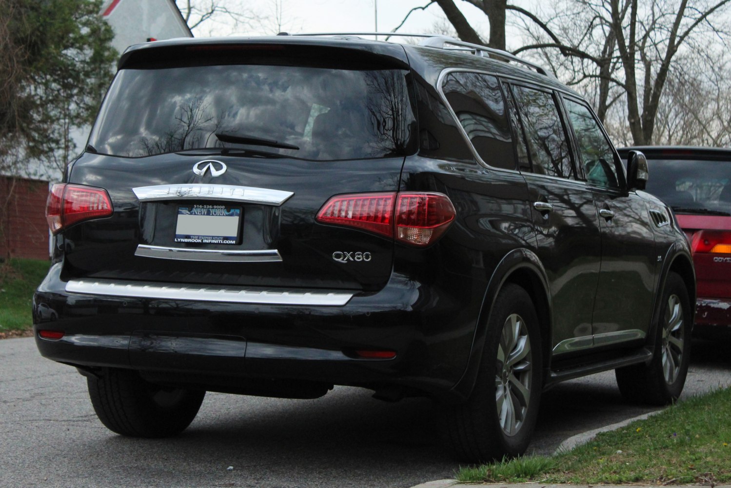 Rear view of full-size luxury SUV with chrome trim and tinted windows