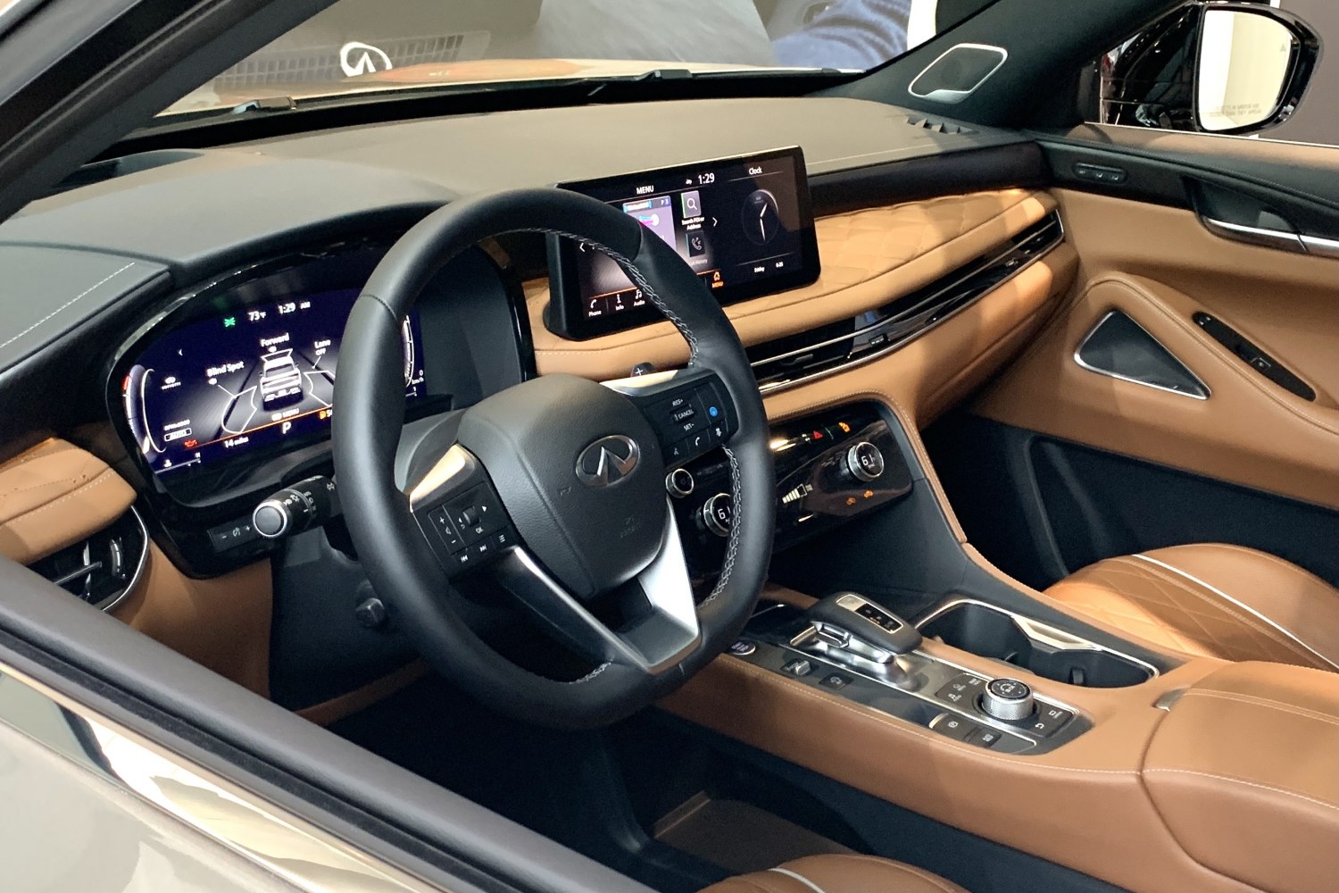 Digital dashboard and infotainment screen with leather-trimmed steering wheel