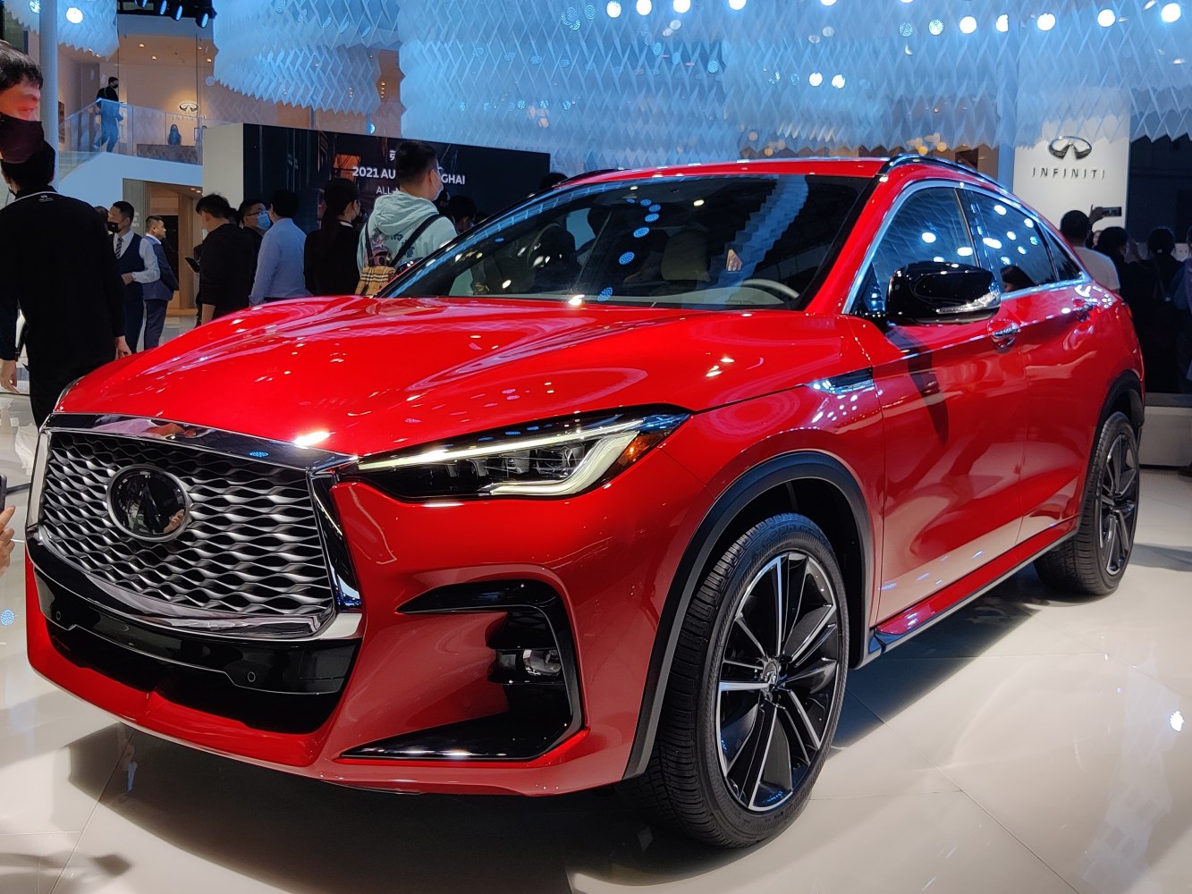Red modern SUV with large front grille and sleek headlights