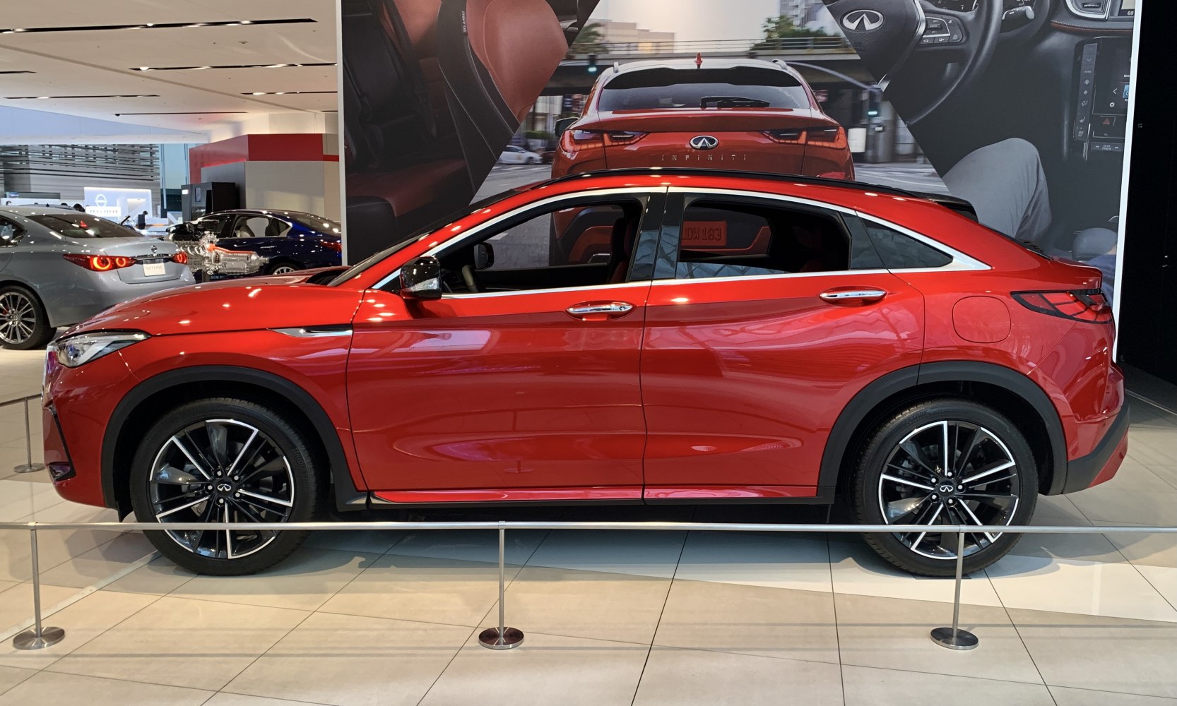 Red crossover SUV with black alloy wheels and chrome window trim