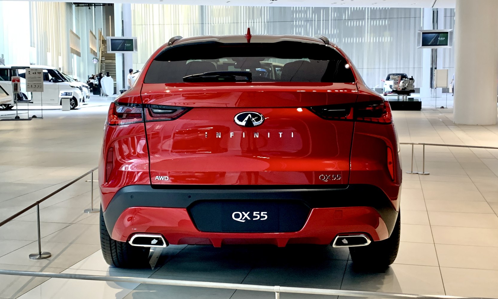 Rear view showing AWD badge, taillights, and dual exhaust tips