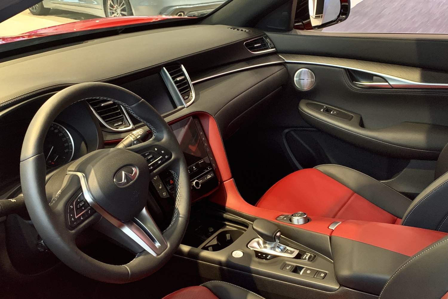 Premium red and black leather interior with detailed steering wheel and dashboard.