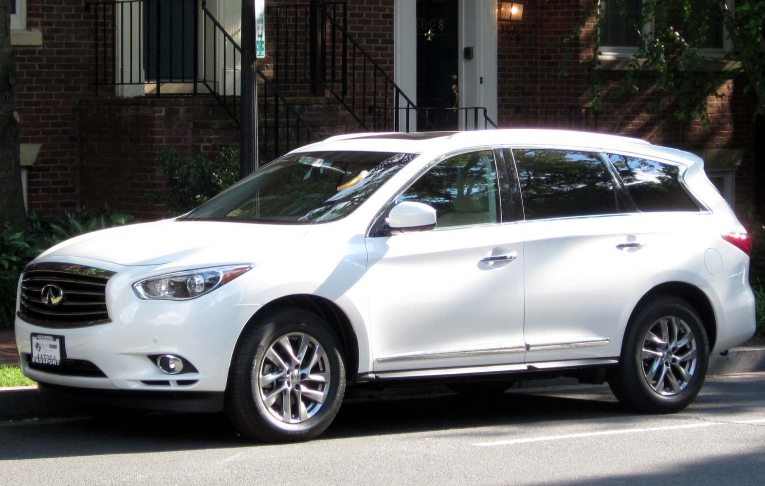 Side profile of white 2013 Infiniti JX SUV with alloy wheels and chrome trim