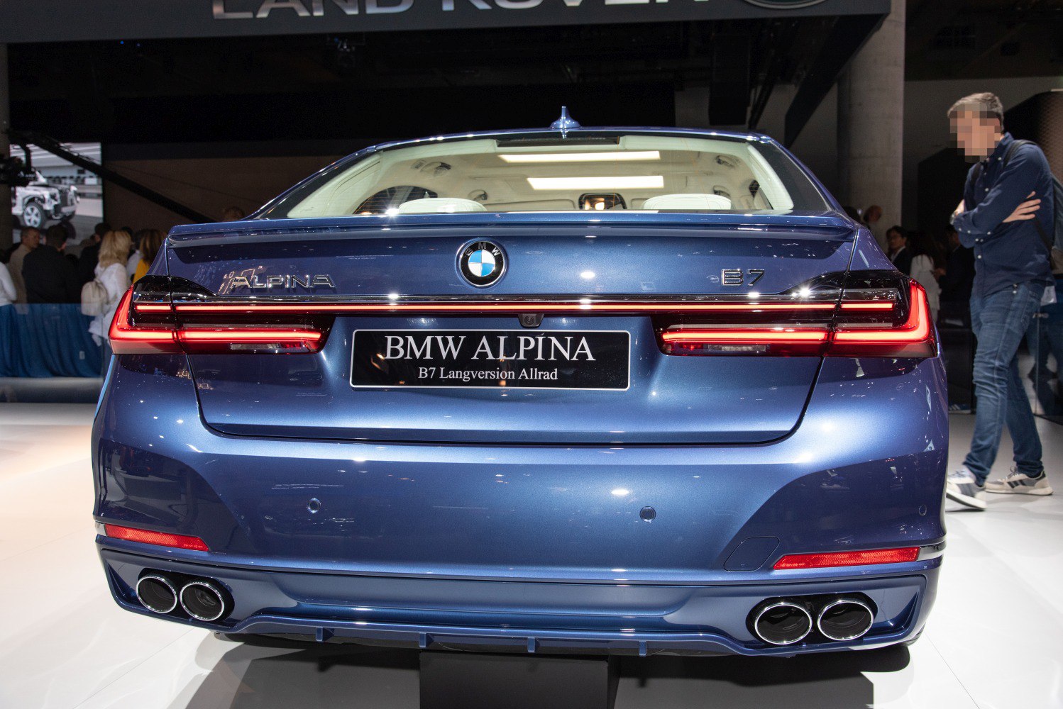 Rear view with LED taillights, trunk spoiler, and quad exhausts