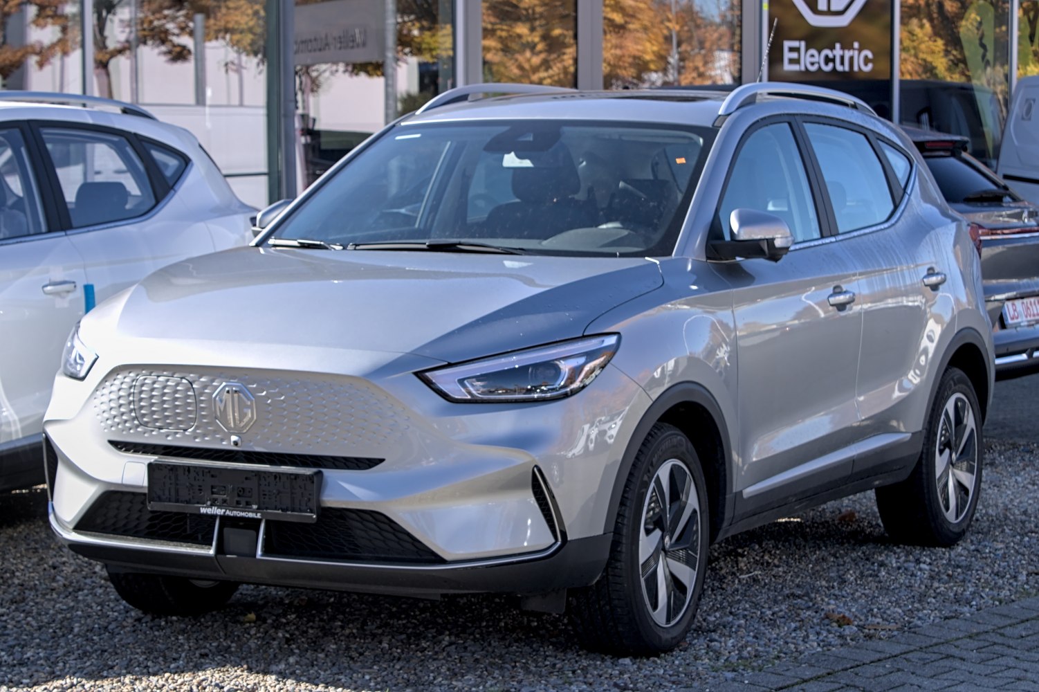 Silver electric SUV with closed grille and sleek LED headlights