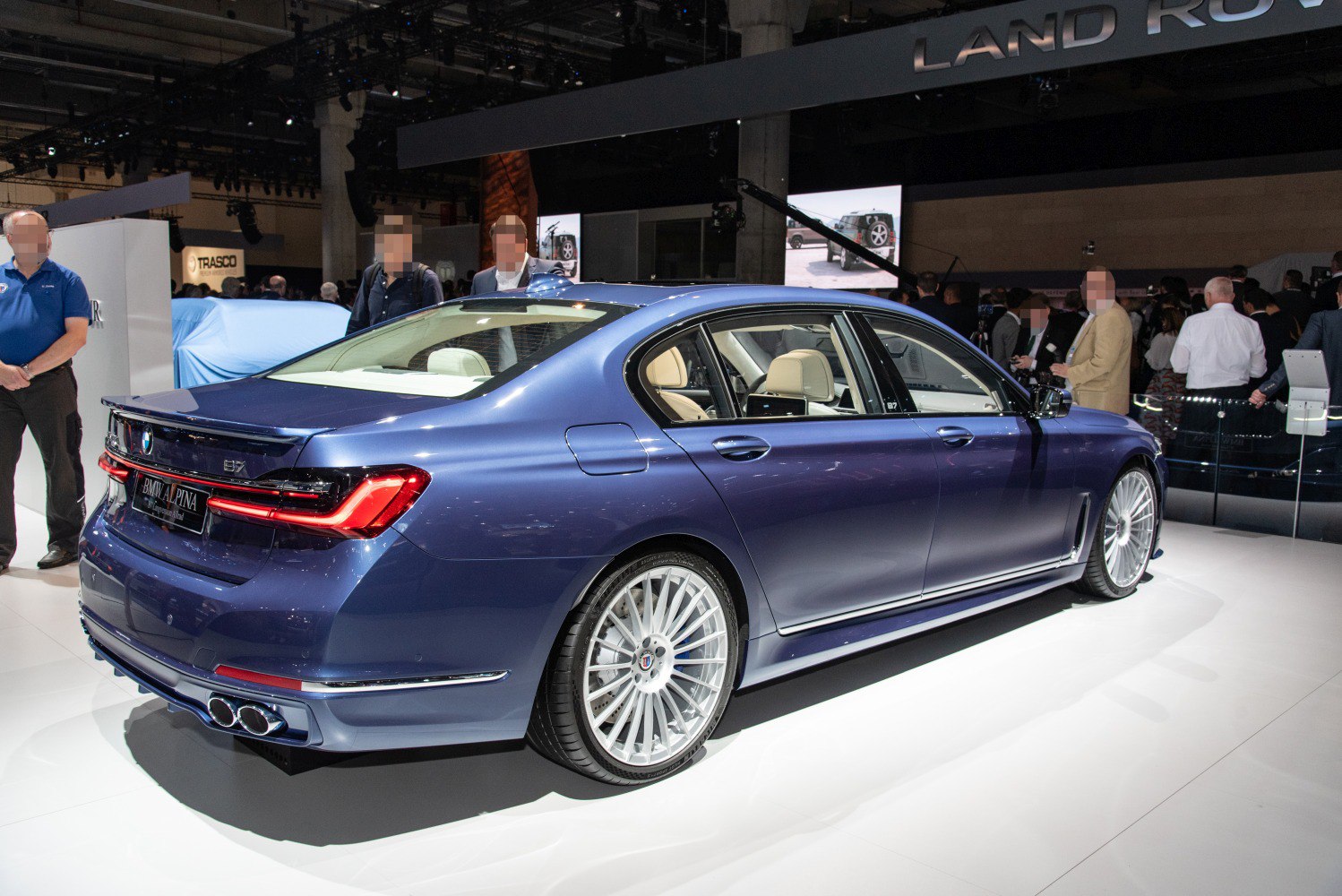 Rear side view with multi-spoke wheels and quad exhaust pipes