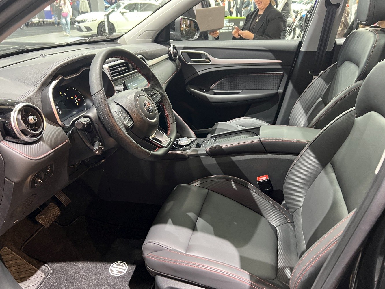 Modern dashboard and premium leather seats with red stitching
