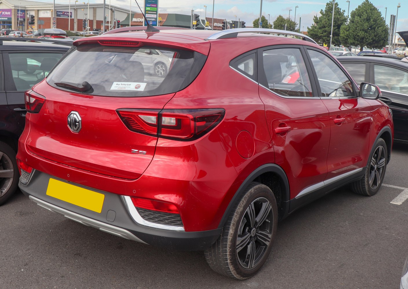 Rear view of red SUV with LED taillights and roof rails