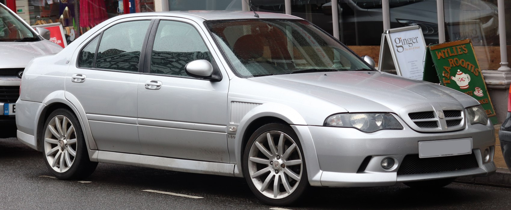 Silver sedan with sporty front grille and alloy wheels