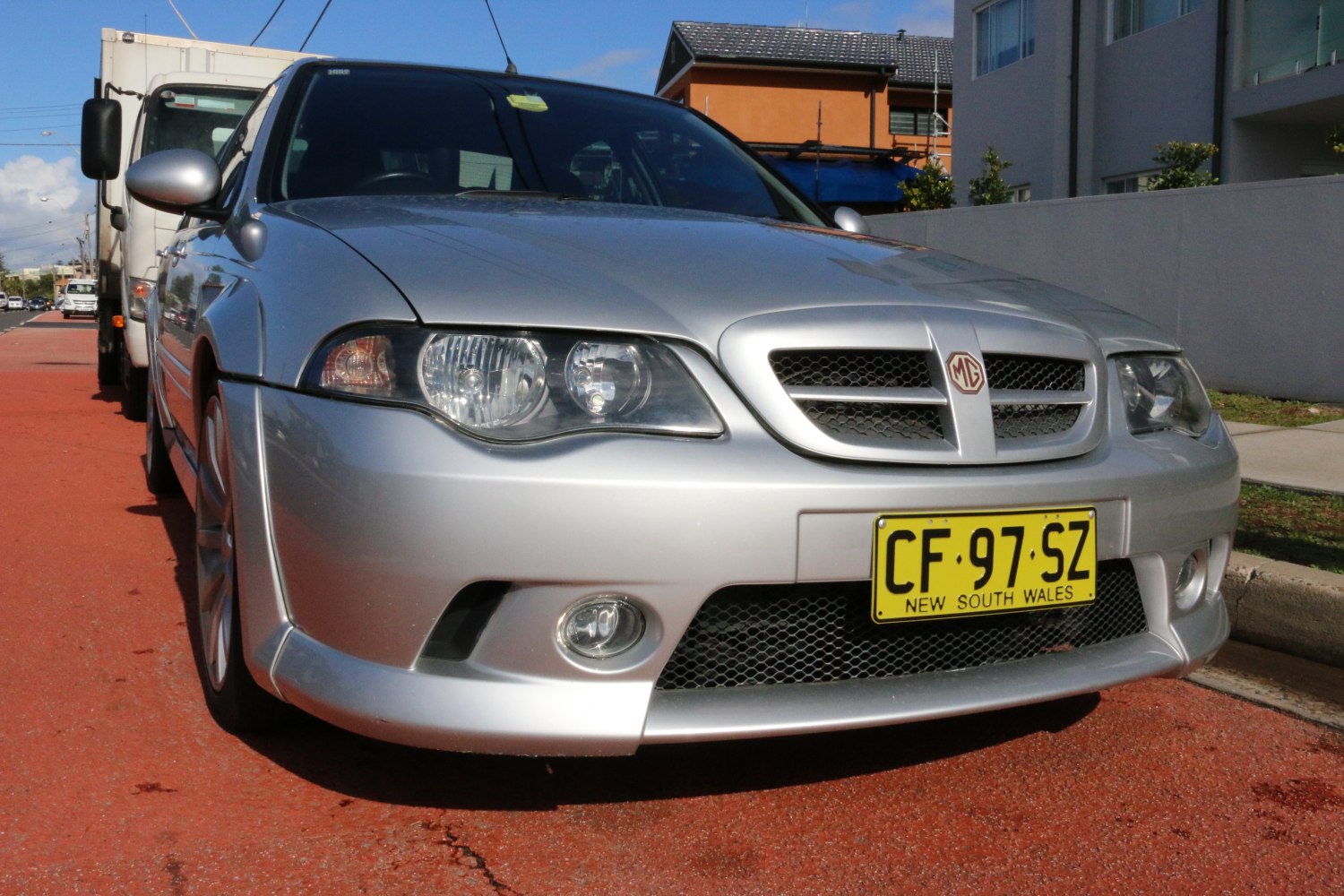 Dual headlights and distinctive front grille with fog lights on silver vehicle