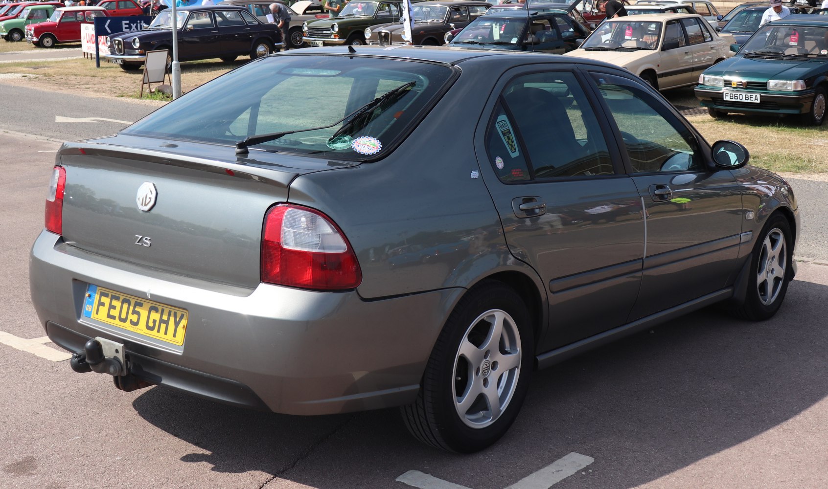Rear and side view of a hatchback with tow hitch and alloy wheels