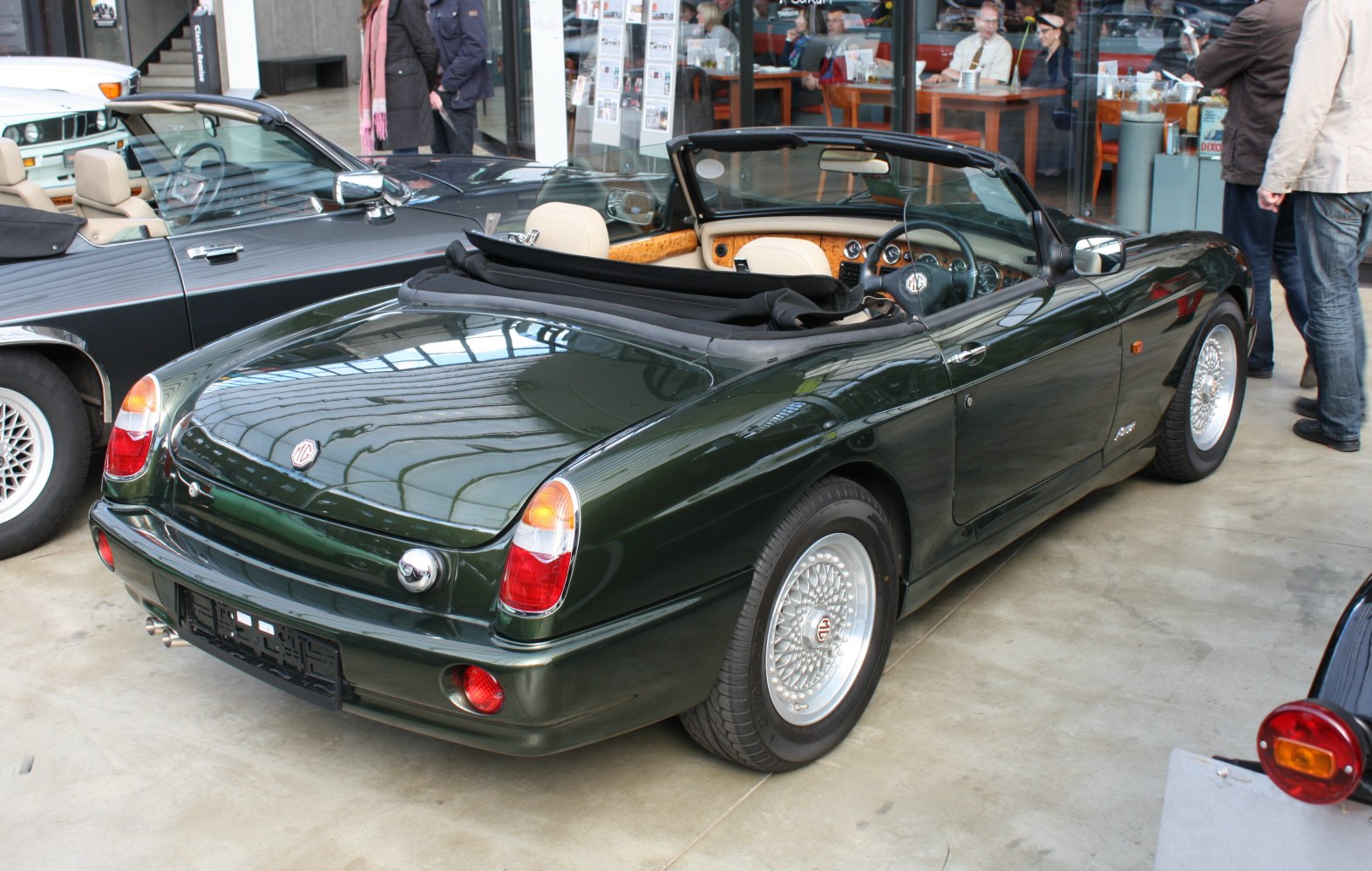 Convertible with wire-spoke wheels and wooden dashboard interior