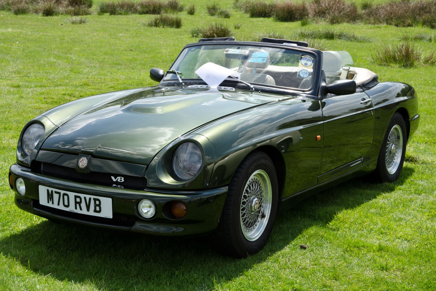 Convertible with V8, wire-spoke wheels, and open-top design