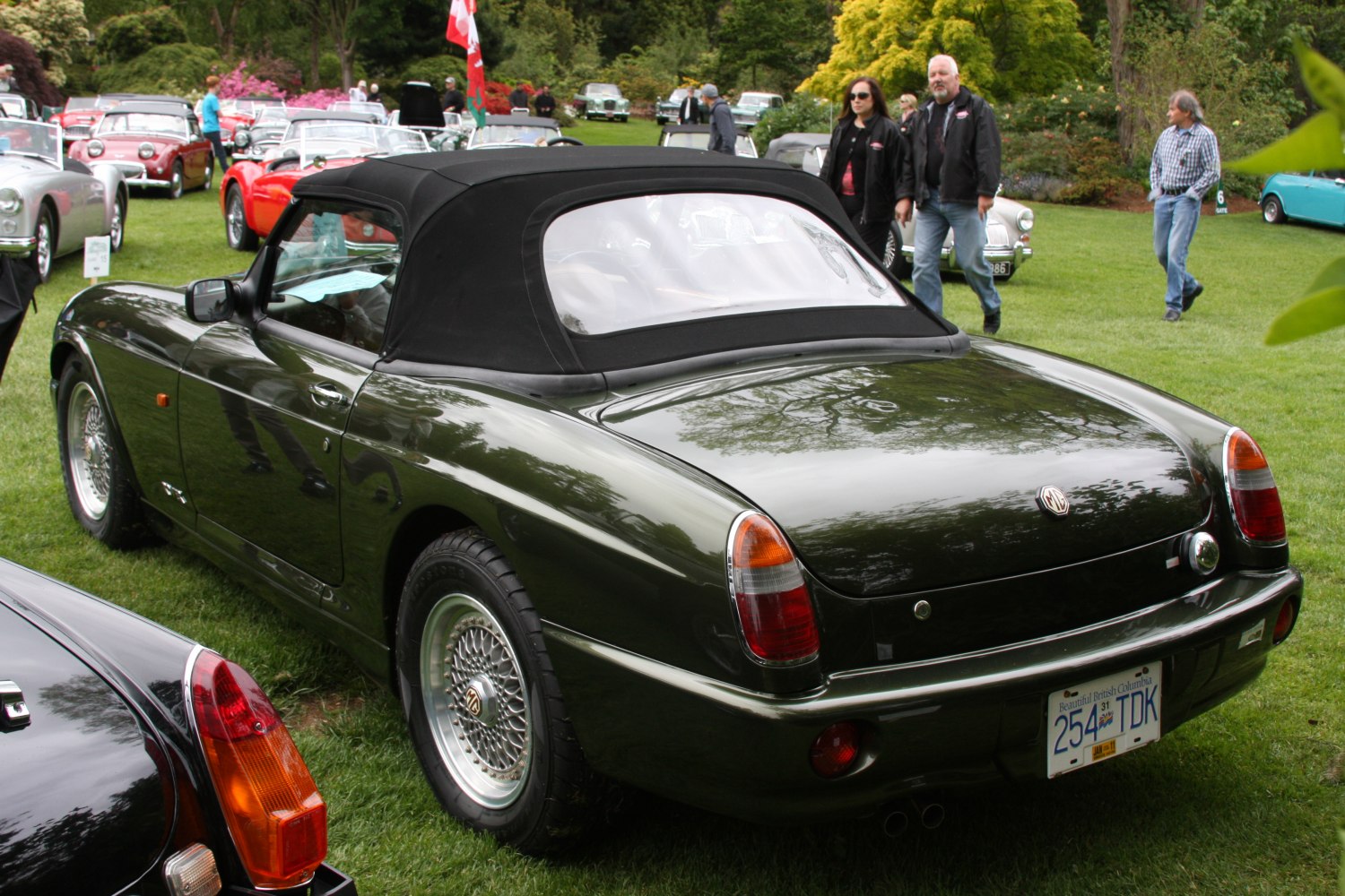 Convertible with black soft top and wire-spoke wheels
