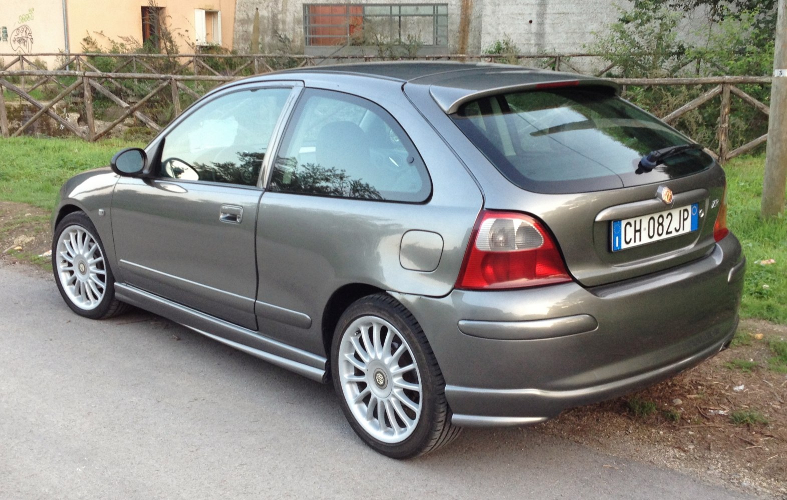 Rear side view of hatchback with alloy wheels and rear spoiler