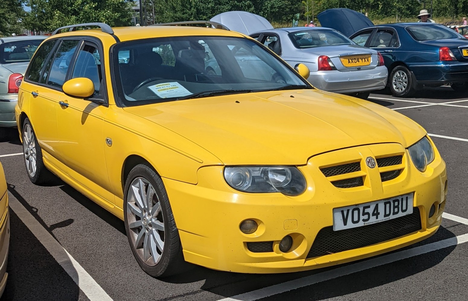 Yellow station wagon with sporty front grille and alloy wheels