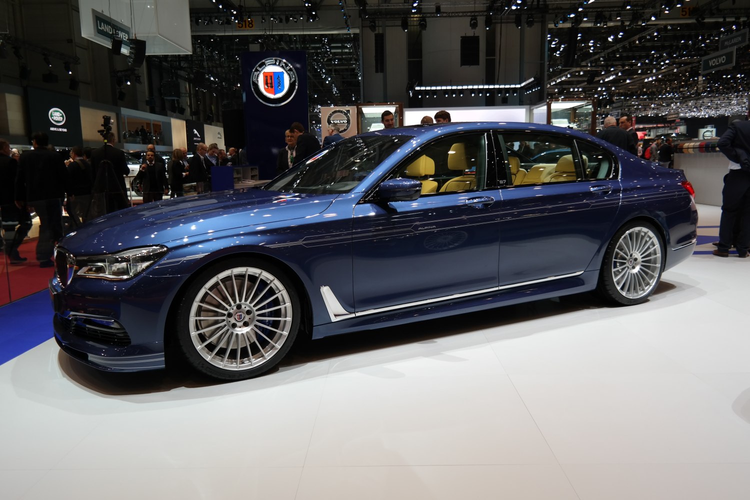 Luxury sedan side profile with signature multi-spoke alloy wheels and distinct design lines