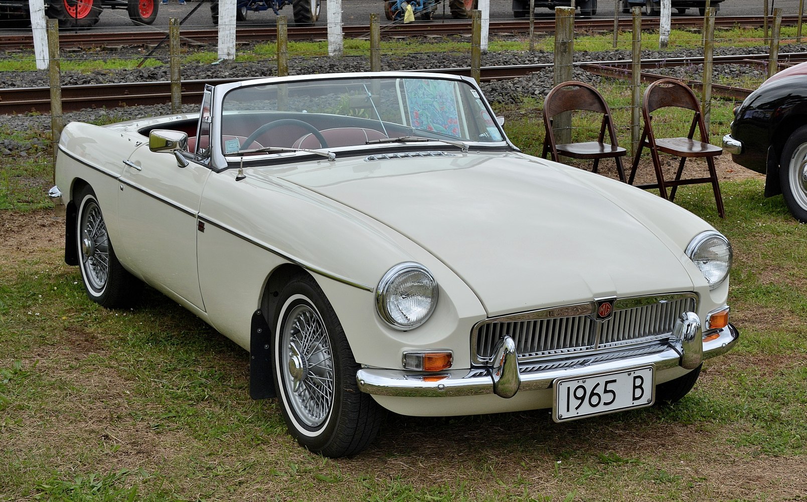 Convertible classic car with round headlights and wire wheels