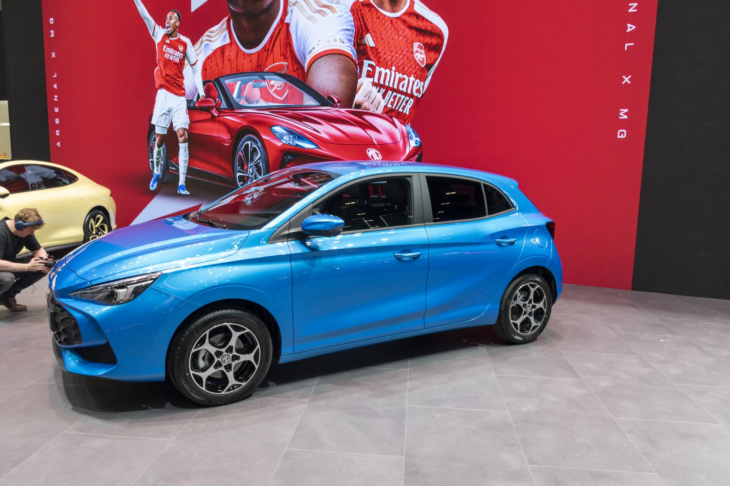 Blue hatchback with sporty alloy wheels and sleek modern headlights