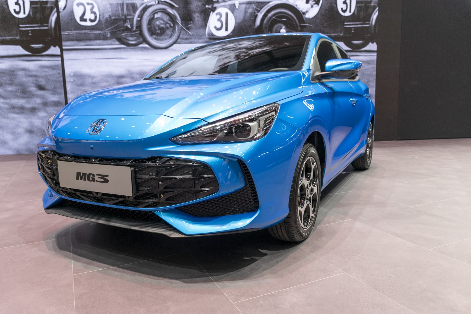 Sharp headlights and bold front grille of blue hatchback