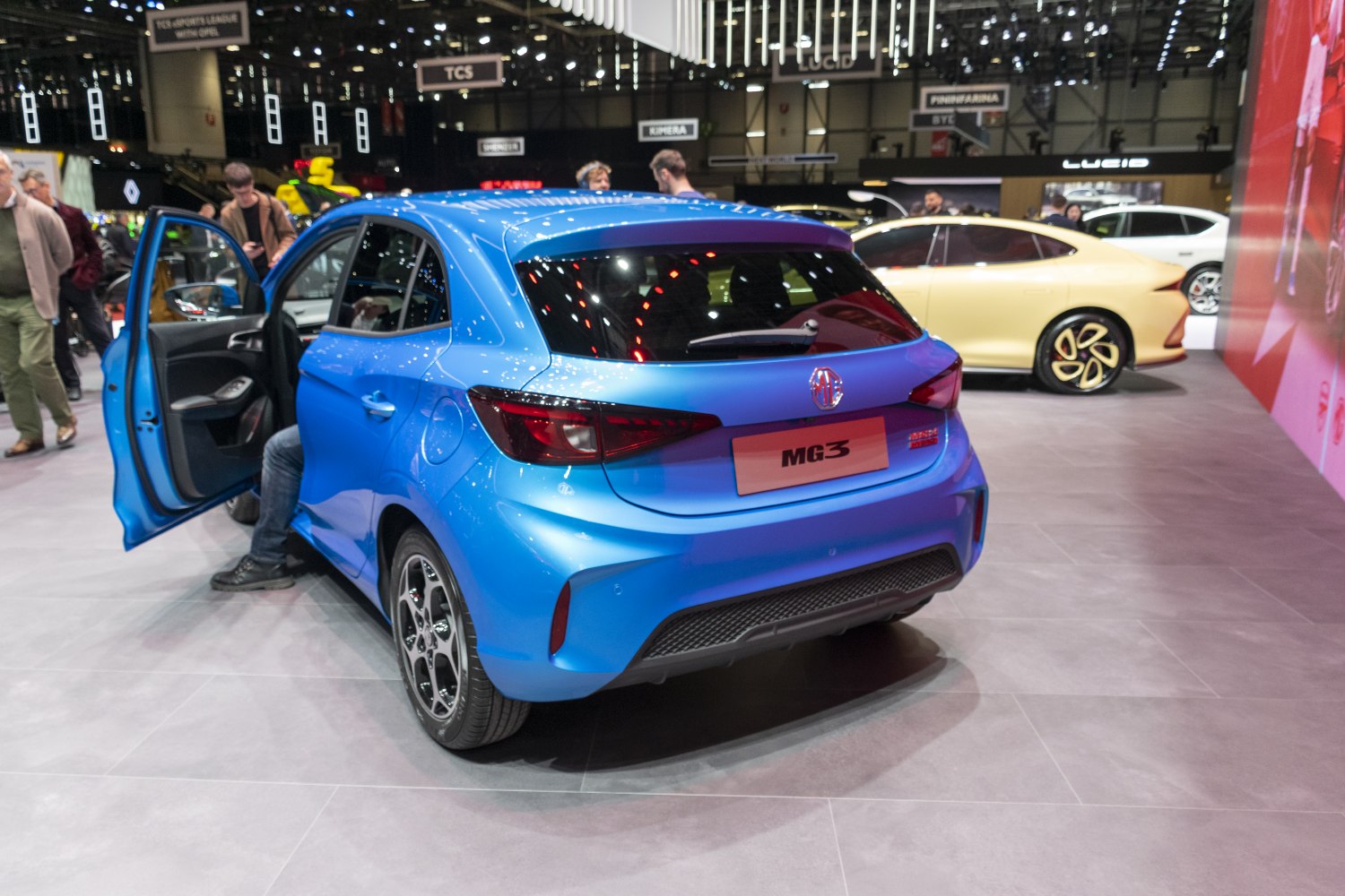 Rear and side view of blue hatchback with open front door