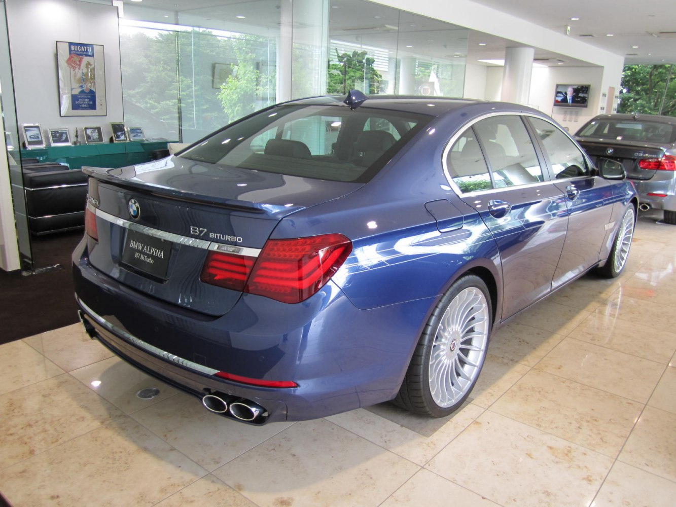 Rear side view with quad exhaust and multi-spoke wheels
