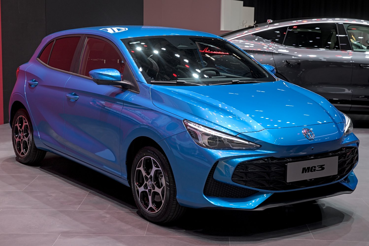 Sporty hatchback front view with sleek headlights and large black grille