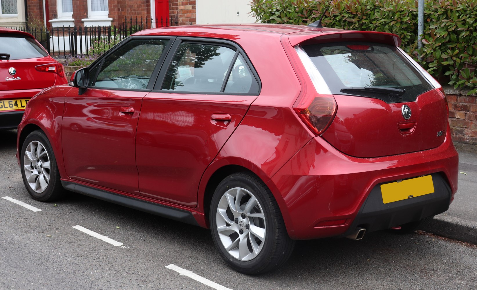 Red compact hatchback rear side and alloy wheels