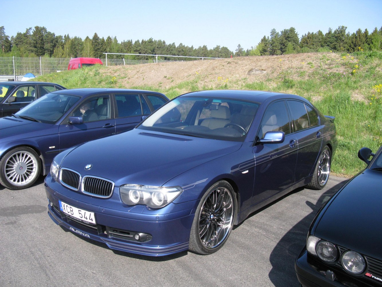Front and side view of luxury sedan with distinctive alloy wheels