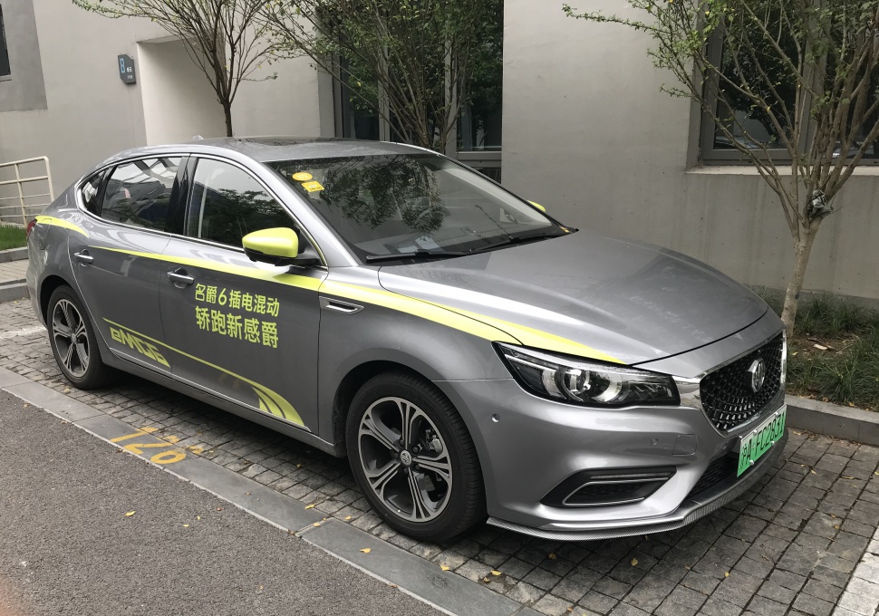 Gray plug-in hybrid sedan with LED headlights and sporty alloy wheels