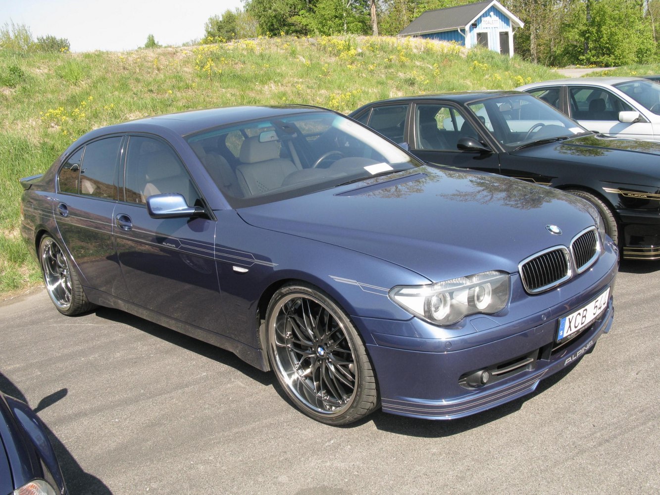Front three-quarter view of luxury sedan with sporty wheels