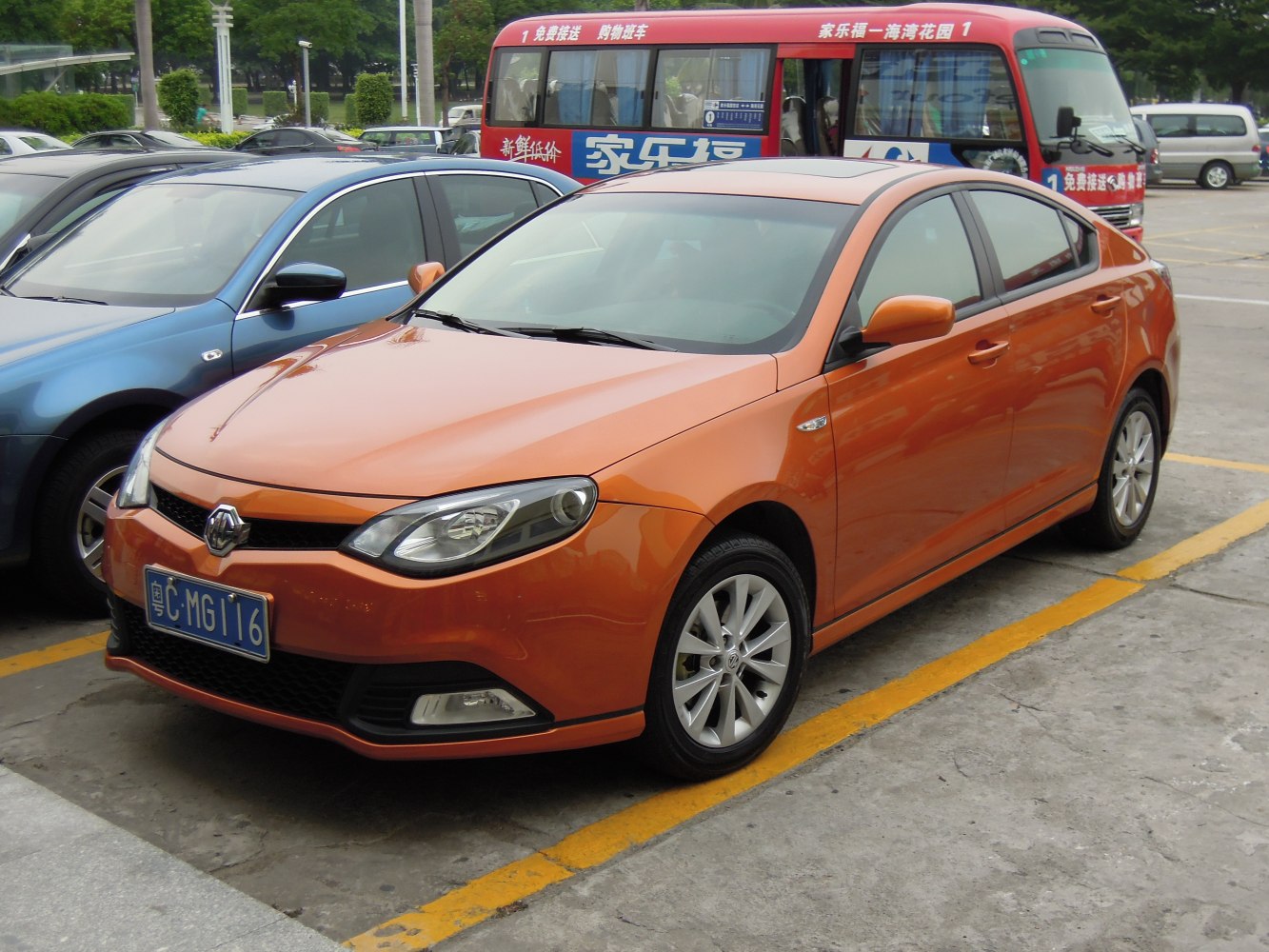 Orange sedan with distinct headlights and alloy wheels