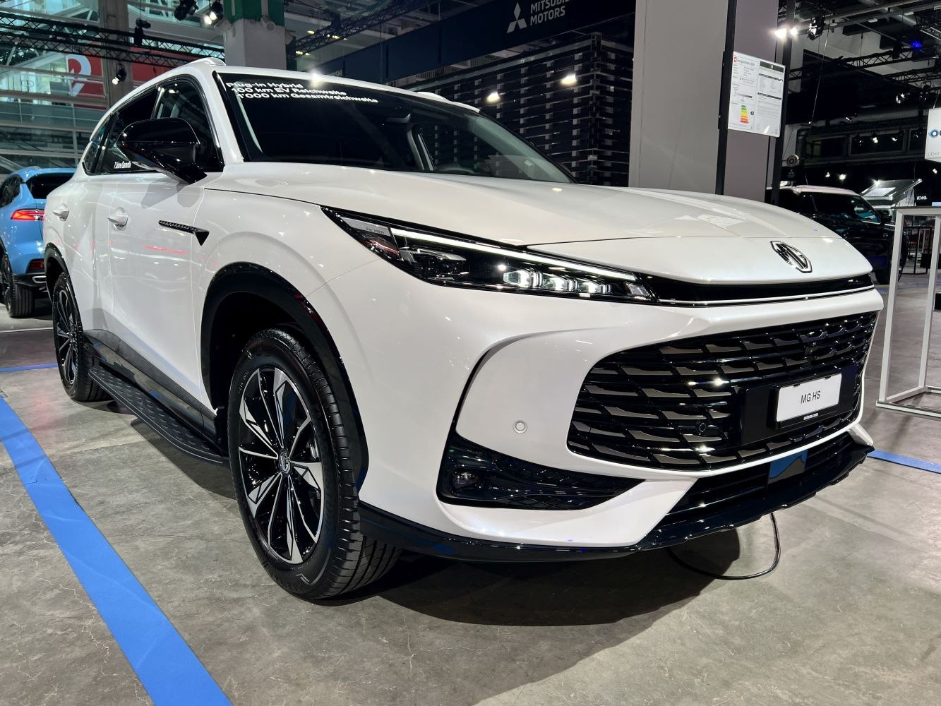 LED headlights and black grille on a modern white SUV front view