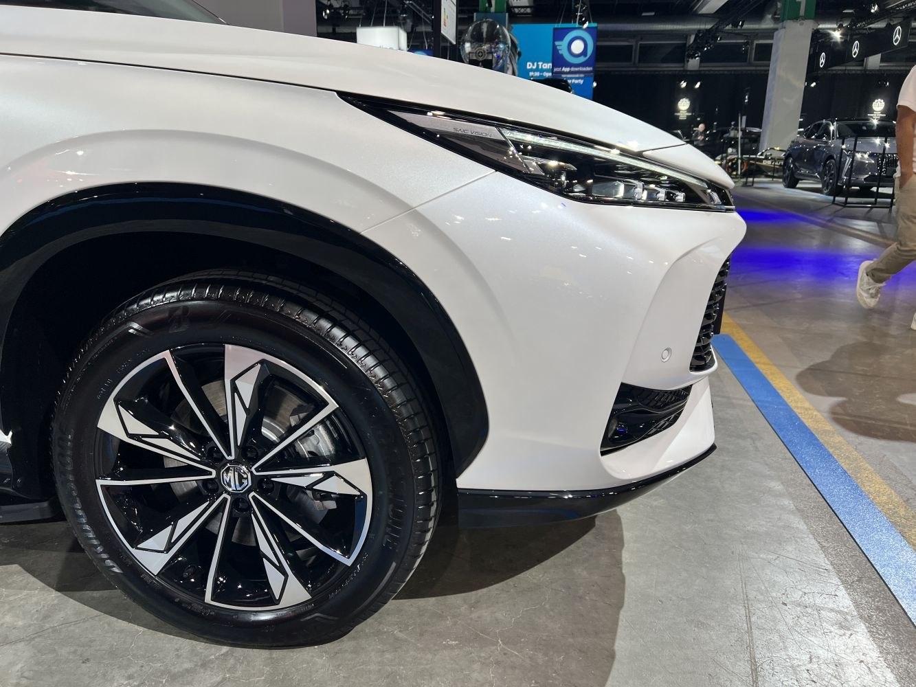 Close-up of alloy wheel and sleek front headlight design