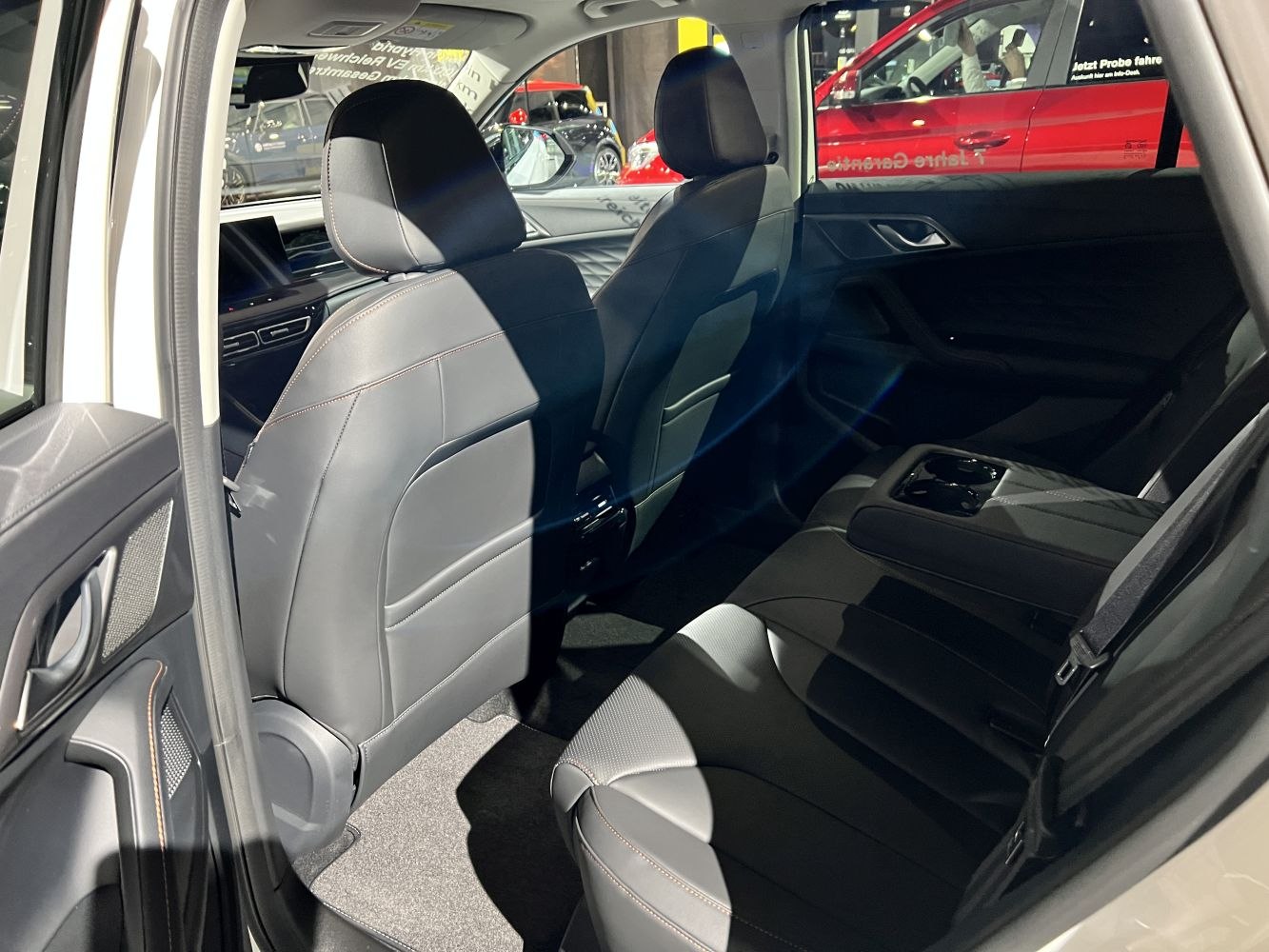 Rear seat area with black leather seats and foldable armrest