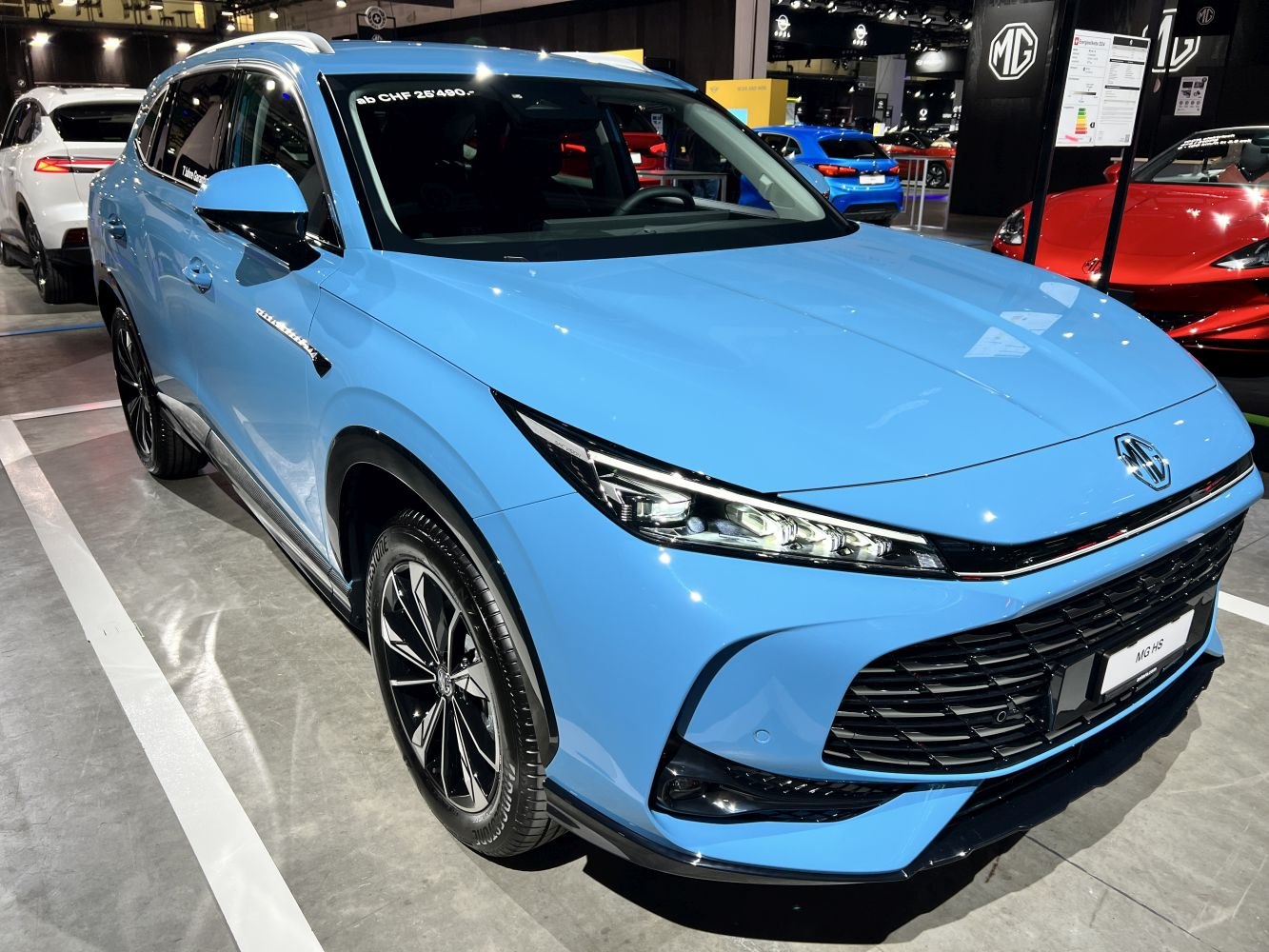 Sky blue SUV with sharp LED headlights and large black grille